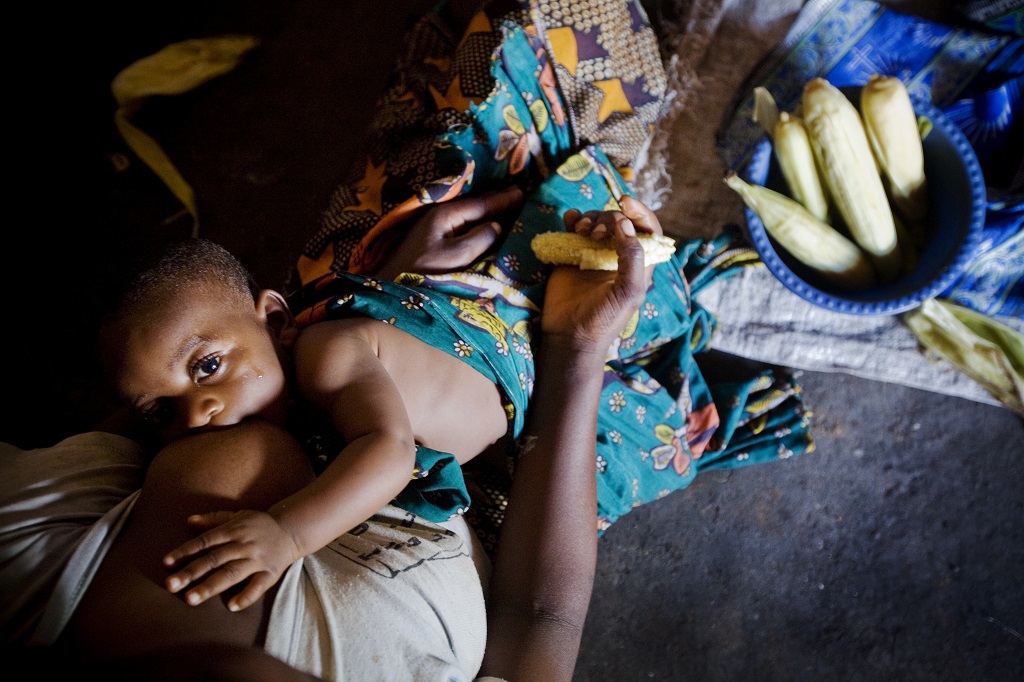 A woman breastfeeds at home in Tanzania.