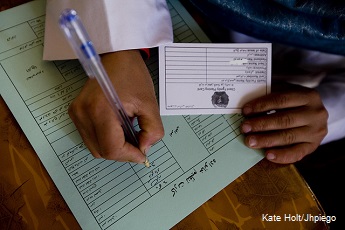 Community midwife completes a form at a community health center near Bamyan, Afghanistan