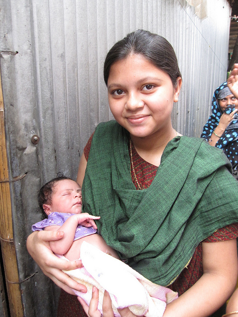 Mother and baby in Dhaka slums, India