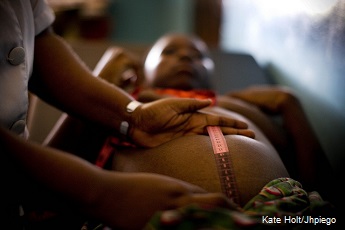 A pregnant woman is measured by a midwife at a healthcenter near Mtwara, Tanzania
