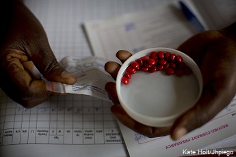 A woman is given iron tablets in her second trimester of pregnancy by a midwife at a health center in Mberara District, Uganda