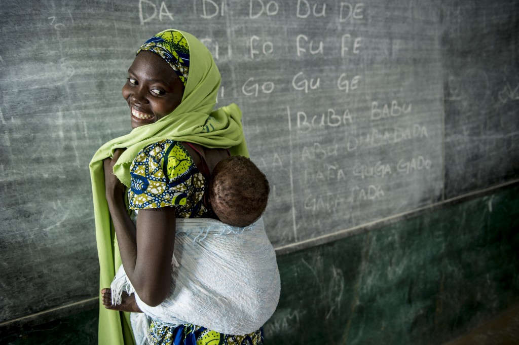 Member of the Nigerian Mada Saving Club for women with her child.