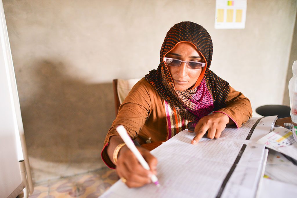 Above: Maintaining accurate health records is an important business practice for midwives like Lateefan Chandio, who are working on their own. (Photo by Ali Khurshid/MCHIP)