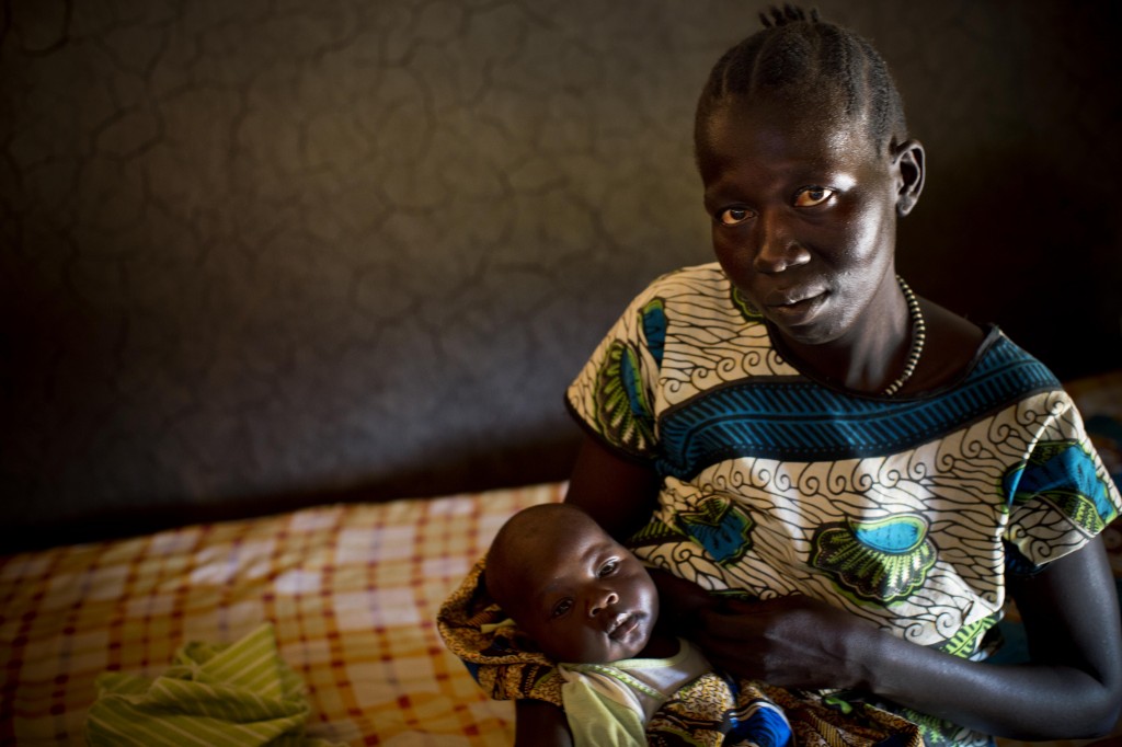 Mother holds her two month old baby, at her home in Lanyi, in Mundri East County South Sudan