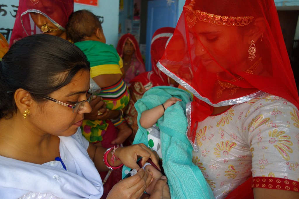 A nurse vaccinates children during an immunization camp in Rajasthan, India.