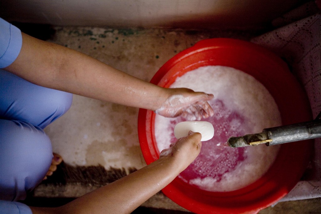 Trainee midwifes attends a practical training session where she learns proper handwashing in Jawjzan, Afghanistan
