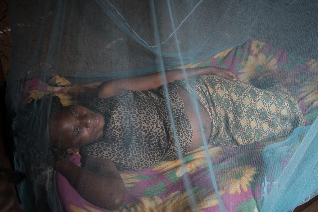 In Kenya, Christine Pepela sleeps under an insecticide-treated bed net provided by a local nurse