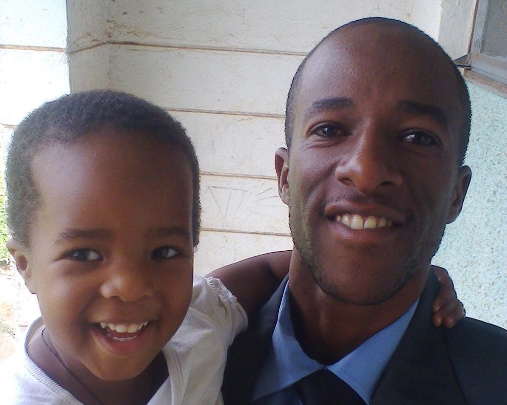 Kenneth and his daughter, Irene, at Itojo Hospital, where all his children were immunized.