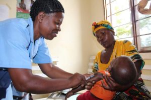 A health provider in Tabora, Tanzania, gives a child an immunization shot.