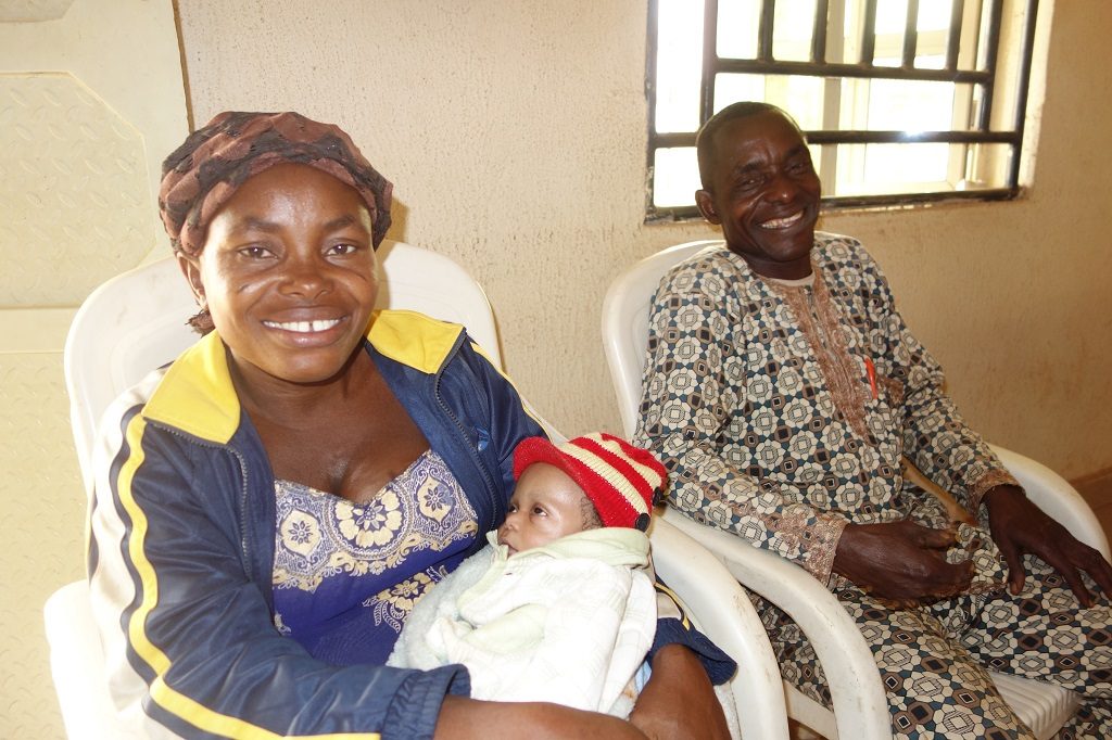 Chinyere Francis and her husband and newborn sitting in chairs