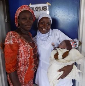 Nurse-midwife Mariam Habib holds Dorcas’s baby.