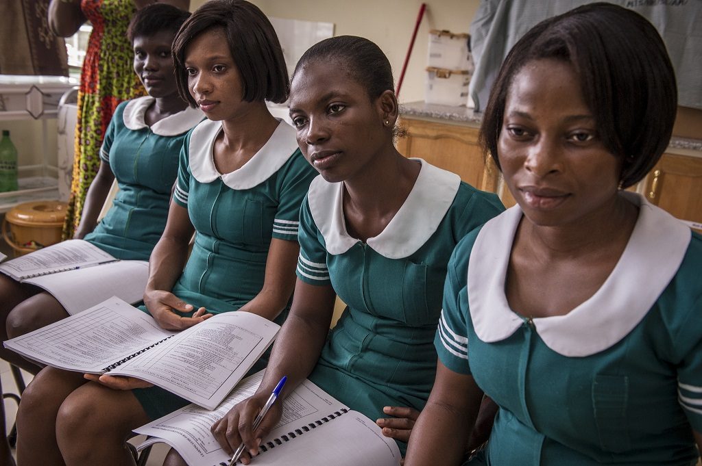 Ghanian midwives watch their instructors do reenactments of women in labor.