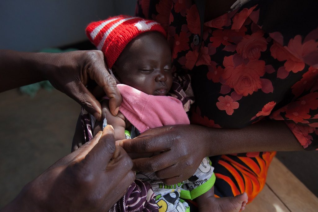 Child receiving a vaccination at a clinic in Malawi