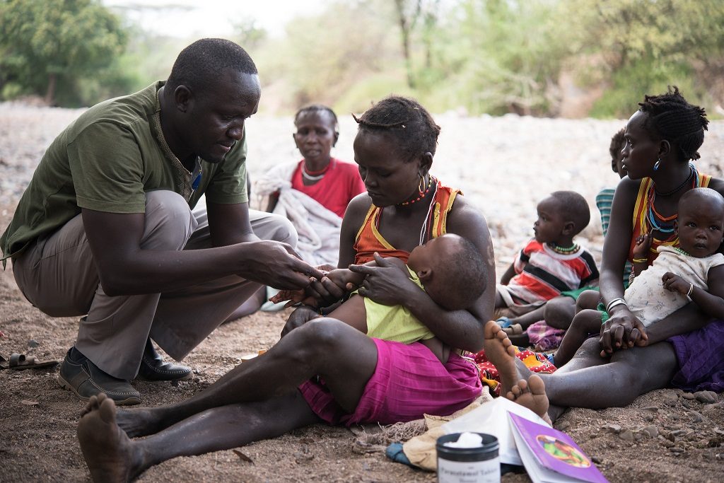 Health worker immunizing a baby during an outreach program in East Pokot, Kenya