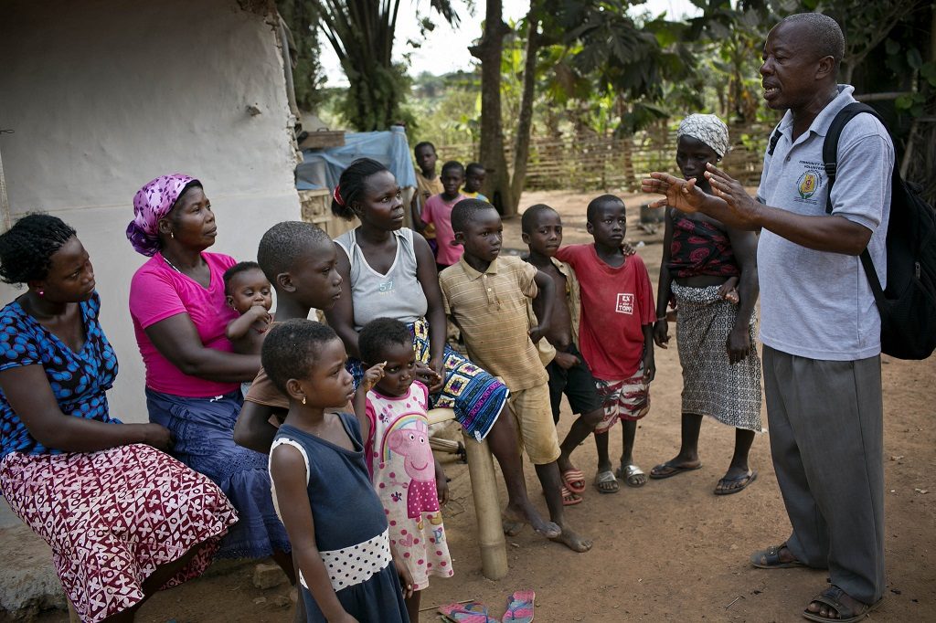 A community health volunteer promoting health messages in Ghana.