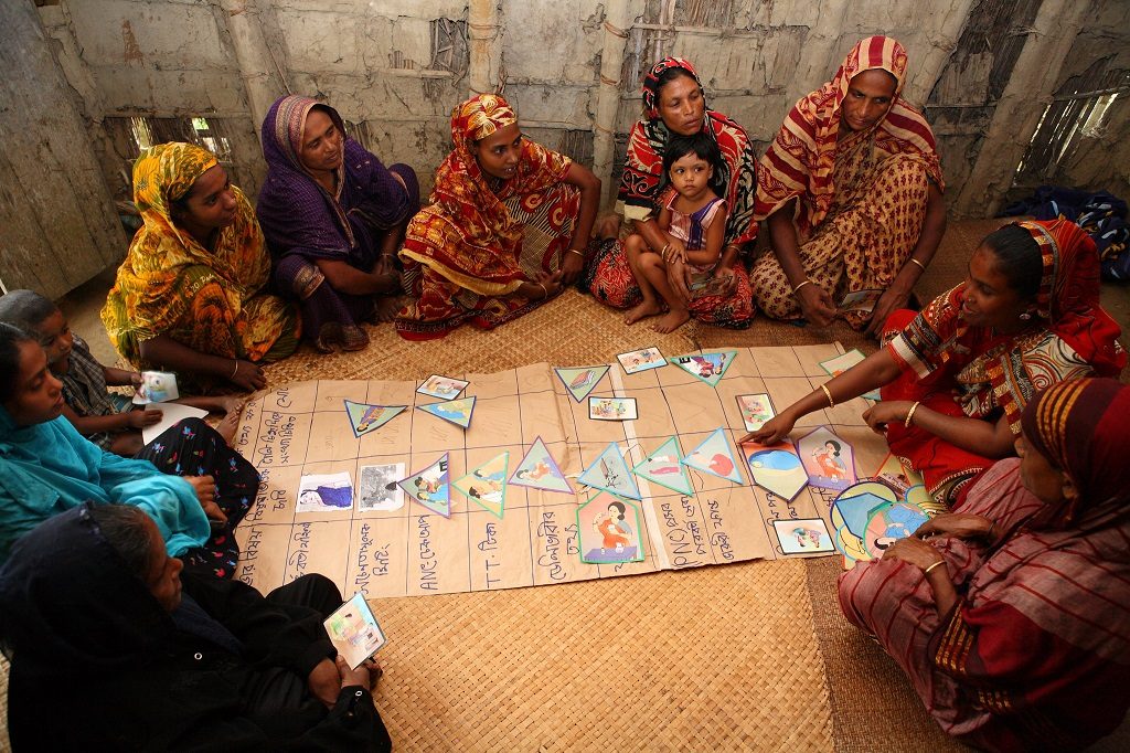Women and children sitting in a circle