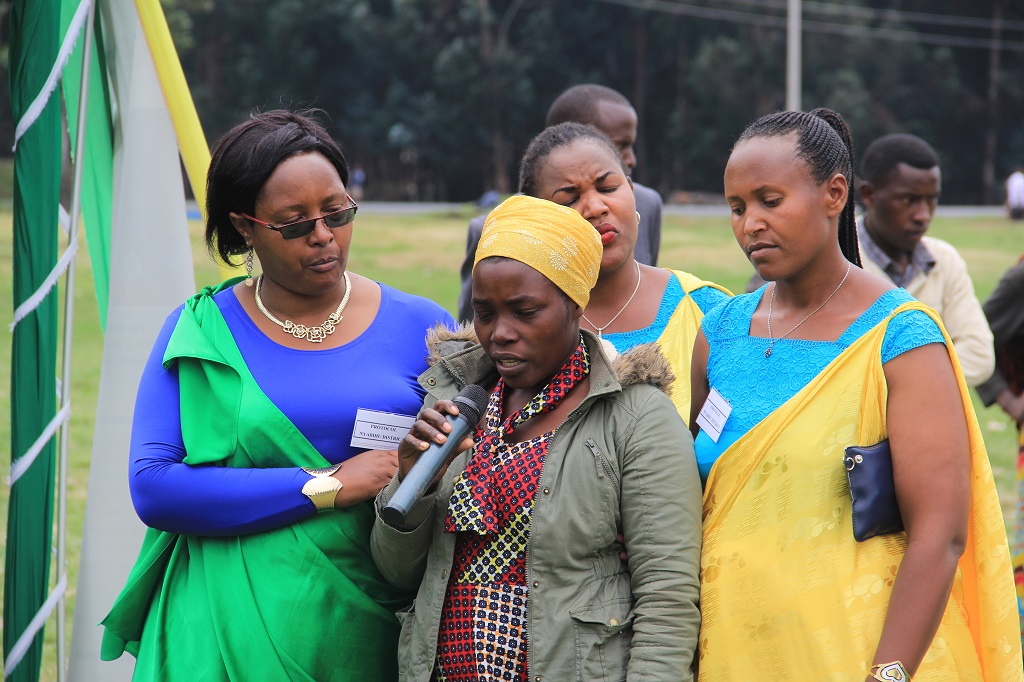 Several months after her fistula surgery, Claudine tells her story to a large crowd.