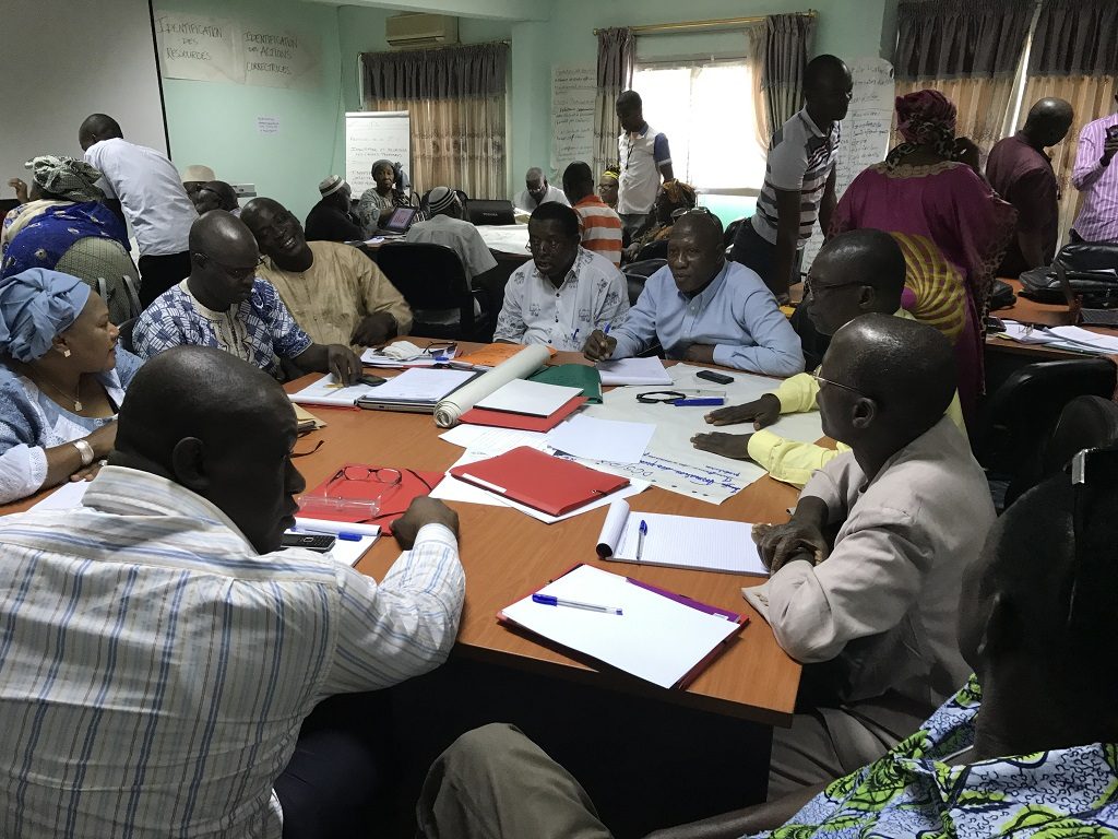 During a regional workshop, district health teams discuss management roles and responsibilities.