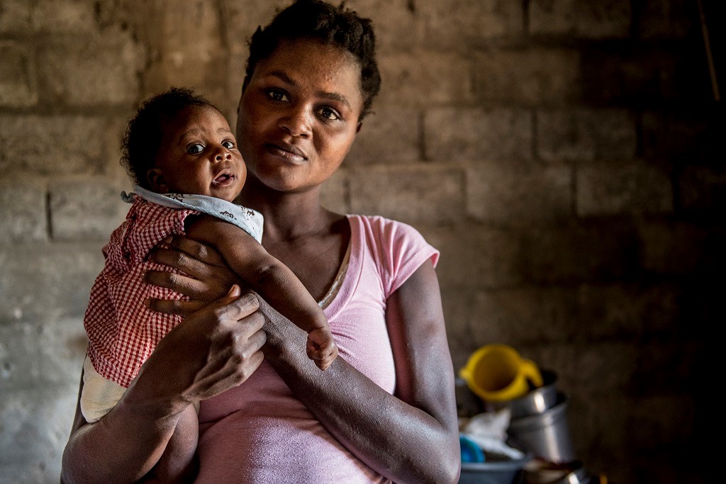 Rosemeline Milord holds her 10-week-old daughter.
