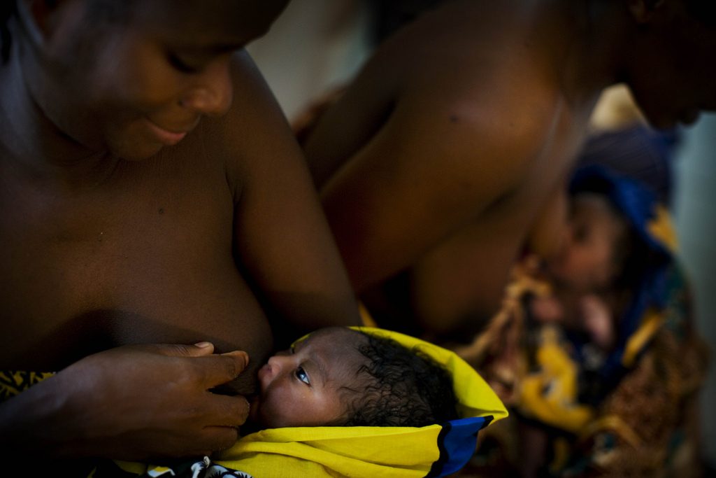 A mother breastfeeds her newborn in Tanzania.