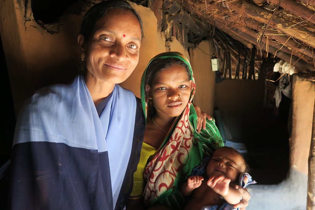 Community health worker Jayanti Laguhuri, at left, with new mother Geetanjali Dehuri at Geetanjali's home