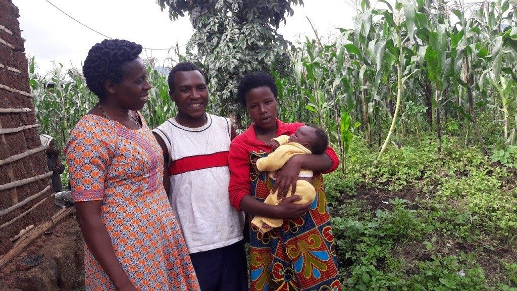 Above: Nurse and mentor Immaculée Ntaneza with the family of a 6-week-old baby she helped to resuscitate after birth.
