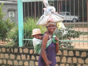Above: A young mother in Madagascar returns from the market with her child.