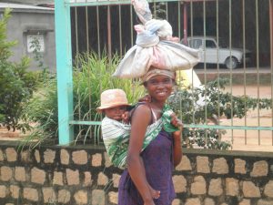 Above: A young mother in Madagascar returns from the market with her child. 