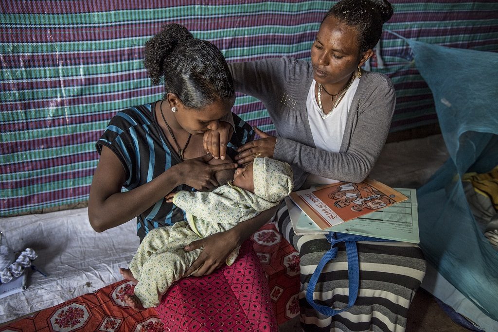 A trained Health Extension Worker in Ethiopia visits the mother of a newborn at home to help her with breastfeeding issues