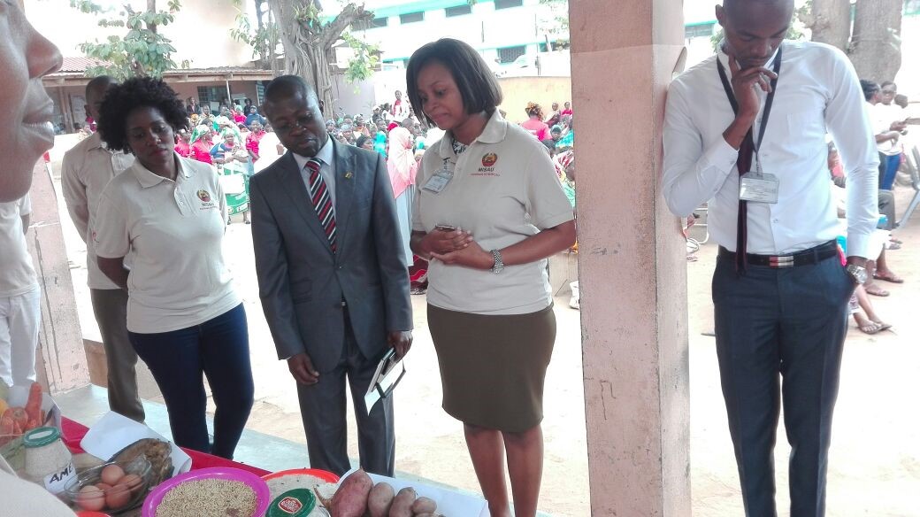 The Provincial Chief Medical Officer, Dr. Sulaimana Isidoro, looking at the locally produced foods during the Nampula City launch ceremony