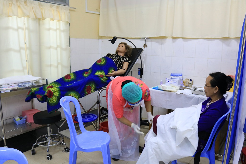 A State Health Training Team Member practicing normal labor and delivery by using the simulation model at Sittwe L&PIC, Rakhine State.