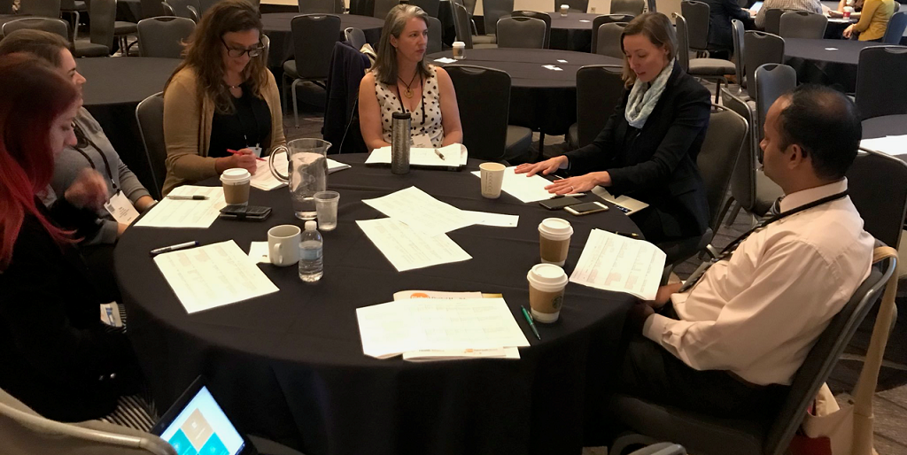 Forum participants reviewing toolkits and providing feedback.