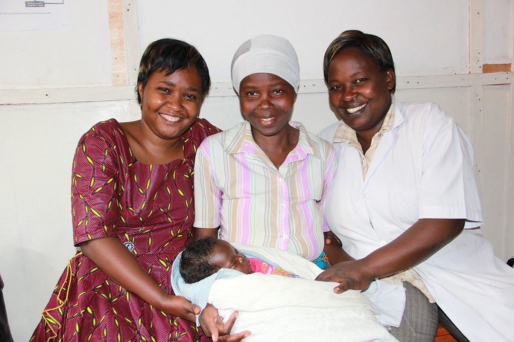 Nurse-mentor Delphine Uwizeyimana; Euphrasie Banyangiriki and baby Irakoze; and nurse Francoise Murekatete.
