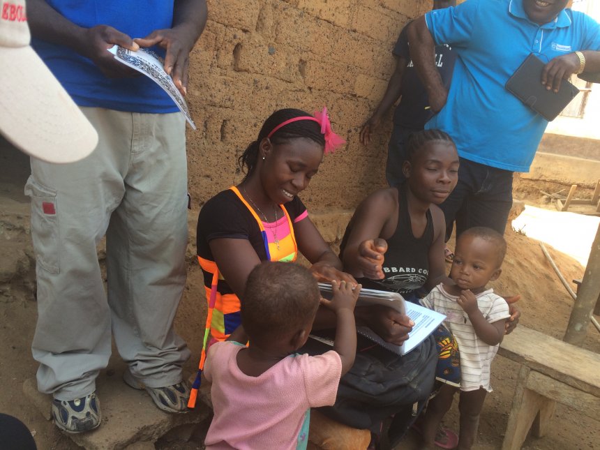 Female Community Health Volunteer interacting with a mother and her under-five children in Nimba County, Liberia