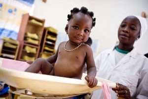 A young girl is weighed in Ziniare Urban Health Facility Ziniare , Burkina Faso