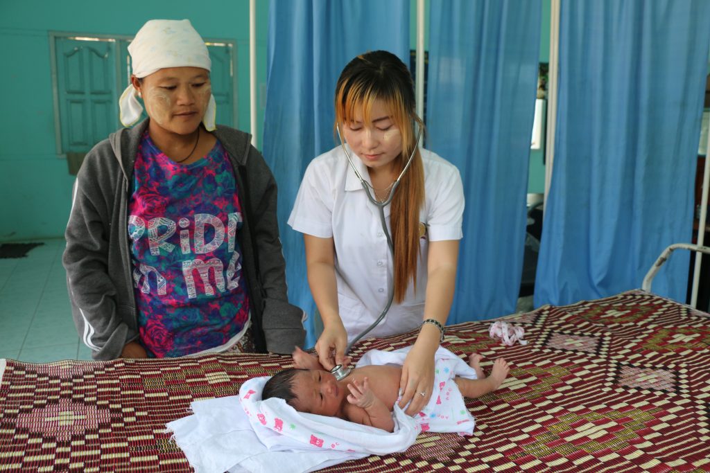 Midwife Naw Eh Paw Htoo examines a baby