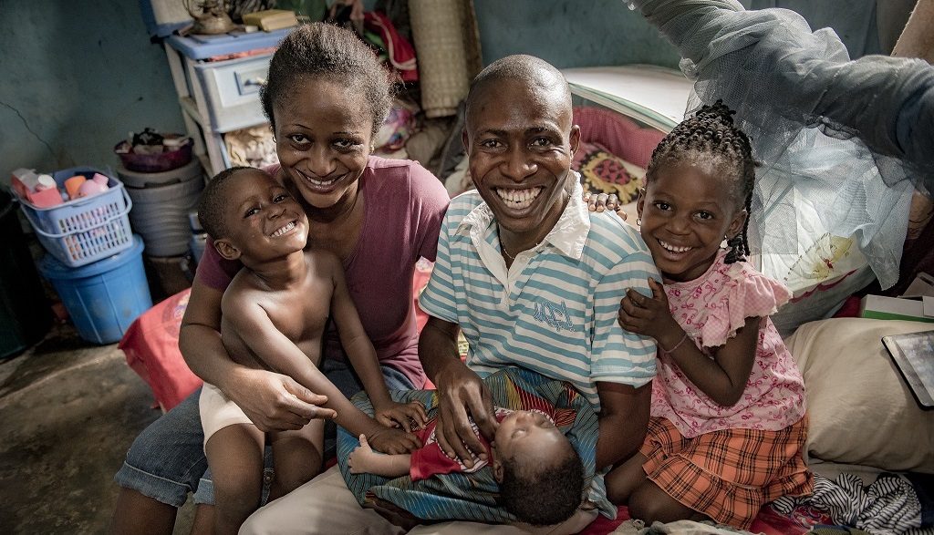 Nwafor Monica and her husband, Israel, with their three children in their home