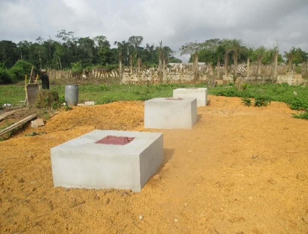 Three separate waste disposal pits for placentas, ash and sharps at Kpallah Clinic in Nimba County, after intervention.