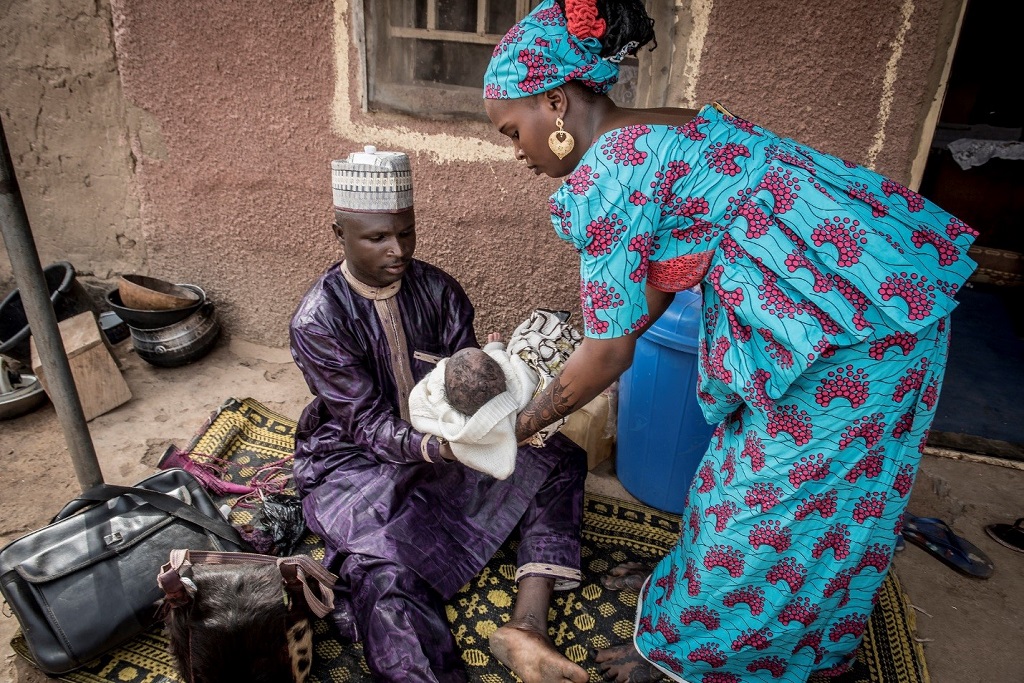 As he prepares to shave her son, he stresses health messages to Nafisatu.