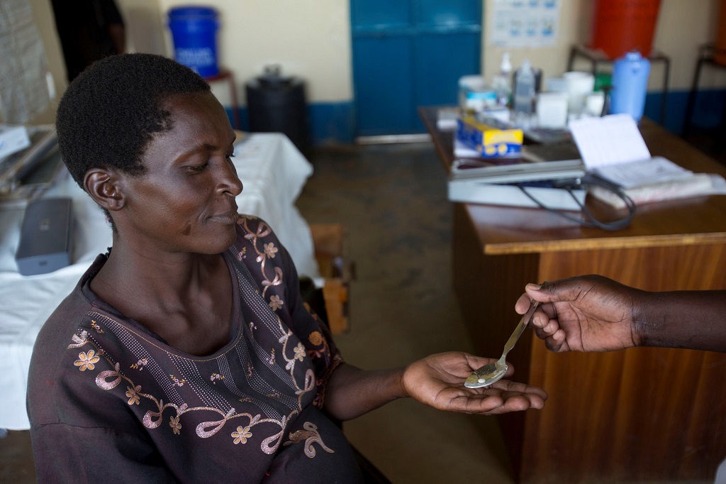 A pregnant woman receives malaria prevention medicine at a clinic in Kenya.