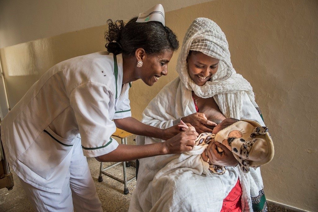 Health care provider with mother and baby