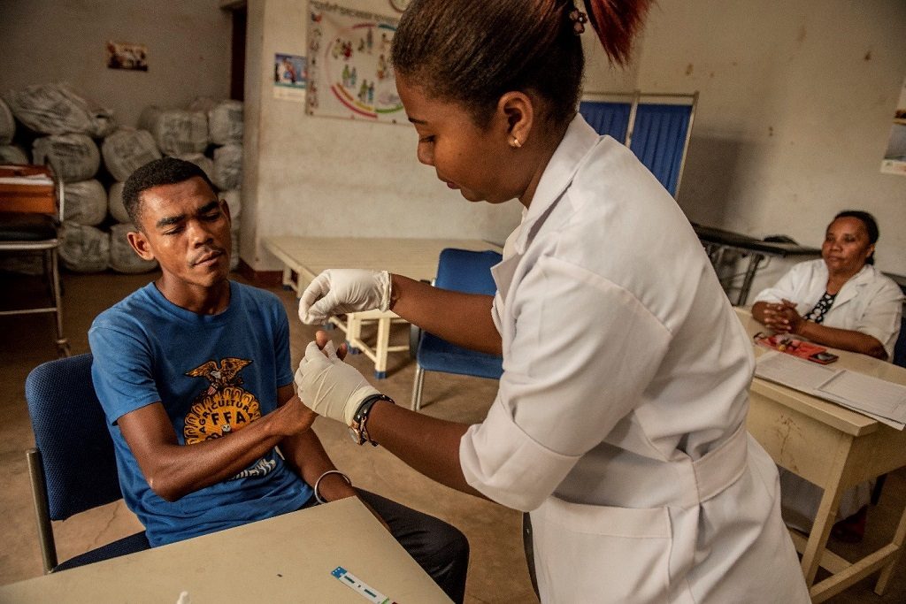 Yrogerette, a community health worker, with father-to-be Ratolojanahary at the health center.