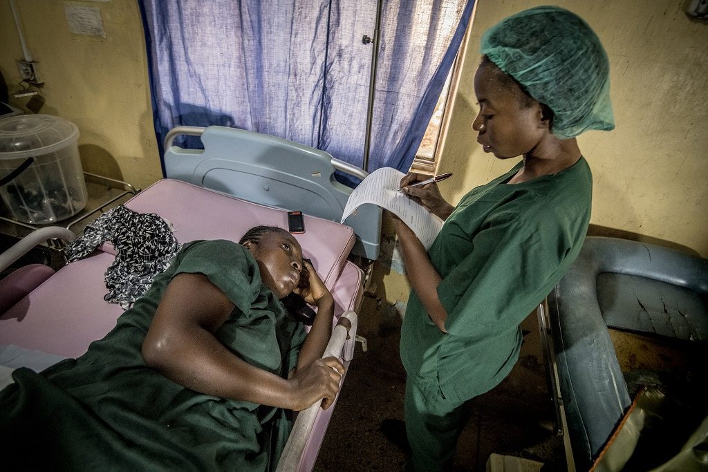 An MCSP-trained midwife in Kogi State uses a partograph to monitor labor progress