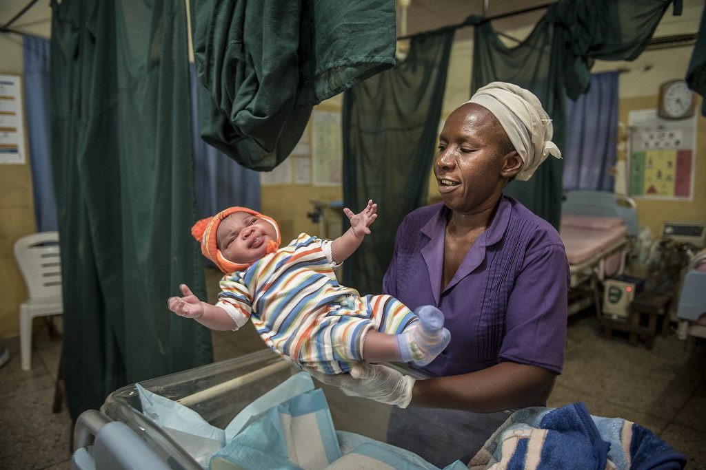 Blessing Malik, a ward attendant at a hospital in Kogi State, cleans and dresses a newborn after birth