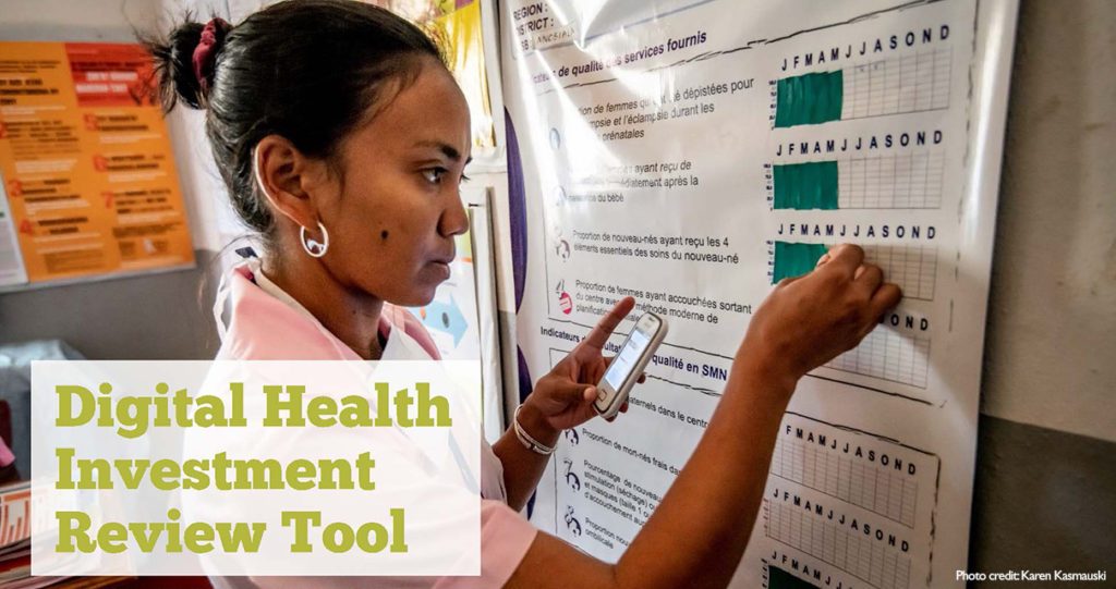 Health worker inputting data to a wall chart