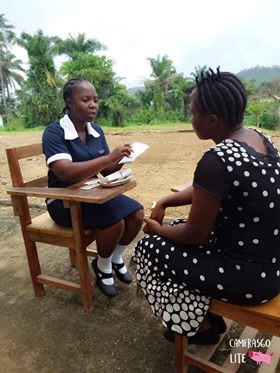 Linda Kharke, a family planning peer provider, with a client on the campus of the Esther Bacon School of Nursing and Midwifery.