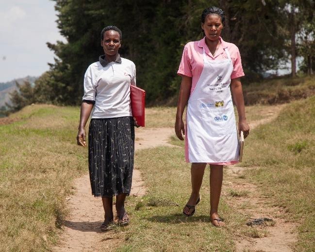 A health worker from Nyabubare Health Center and a village health team member work together to support routine immunization in their community.