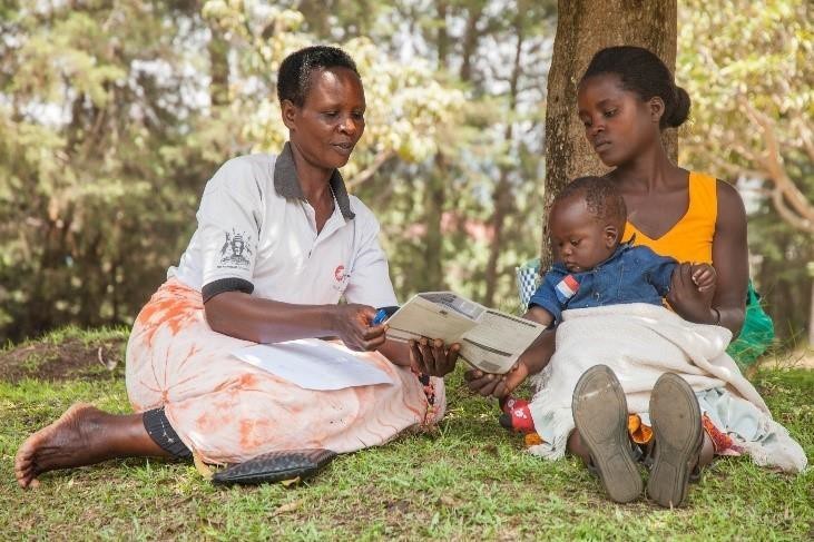 A VHT from Nyabubare Health Center registering the immunization status of a child in her community.