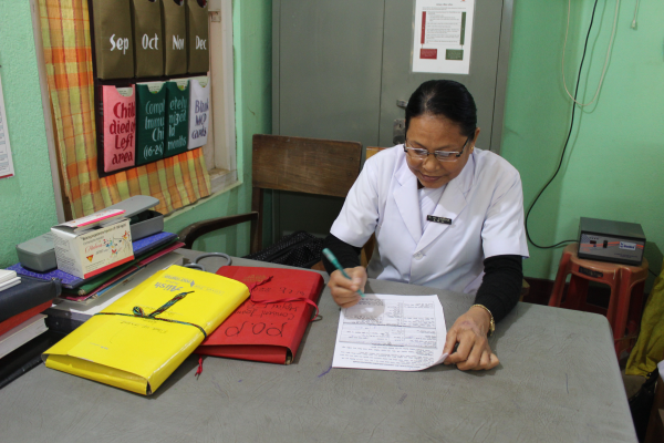 Singha documenting details of FP acceptors in her counseling corner at Hojai-FRU.