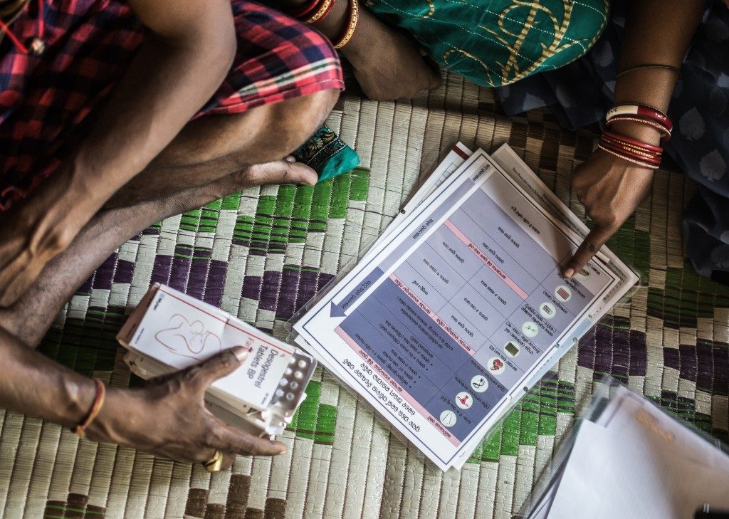 Married couple Jyoti Rani and Pratap Patra meet with Lakshmi Demi, the local community health worker, to discuss family planning options.